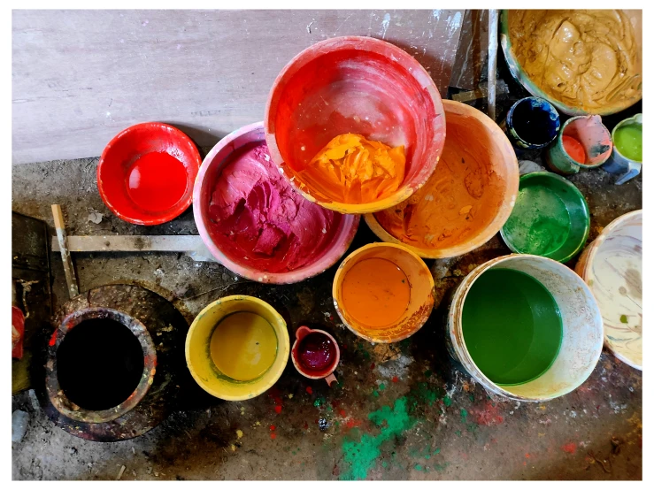 several bowls are shown with paint spilled out