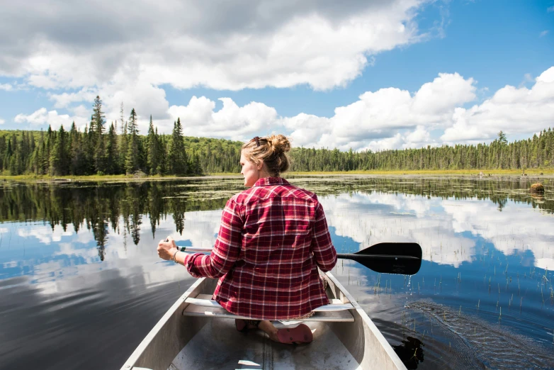 a lady that is sitting in a boat