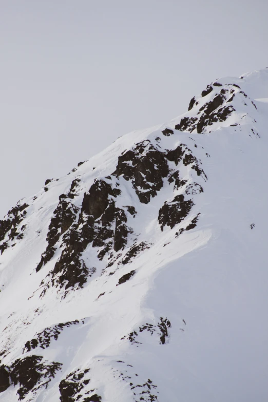 a person on skis is standing at the top of a hill