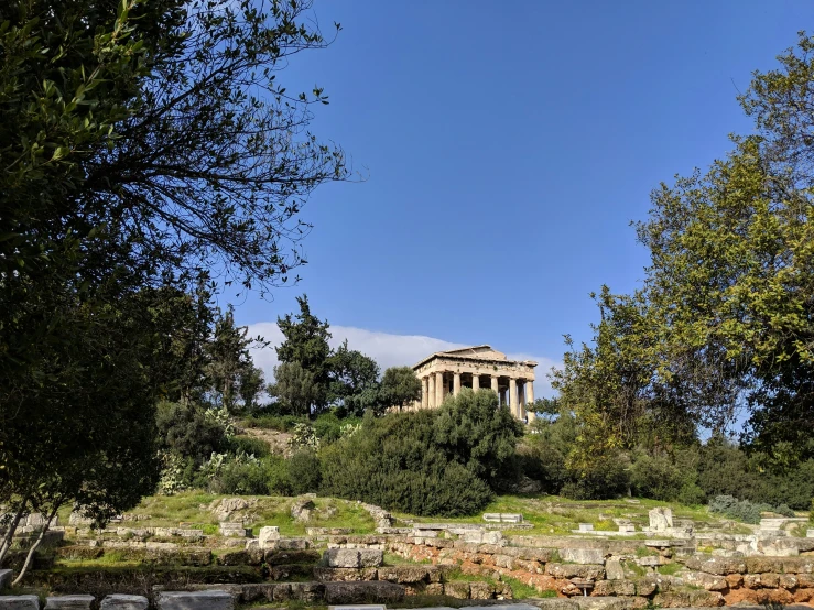 a building surrounded by trees and rocky terrain