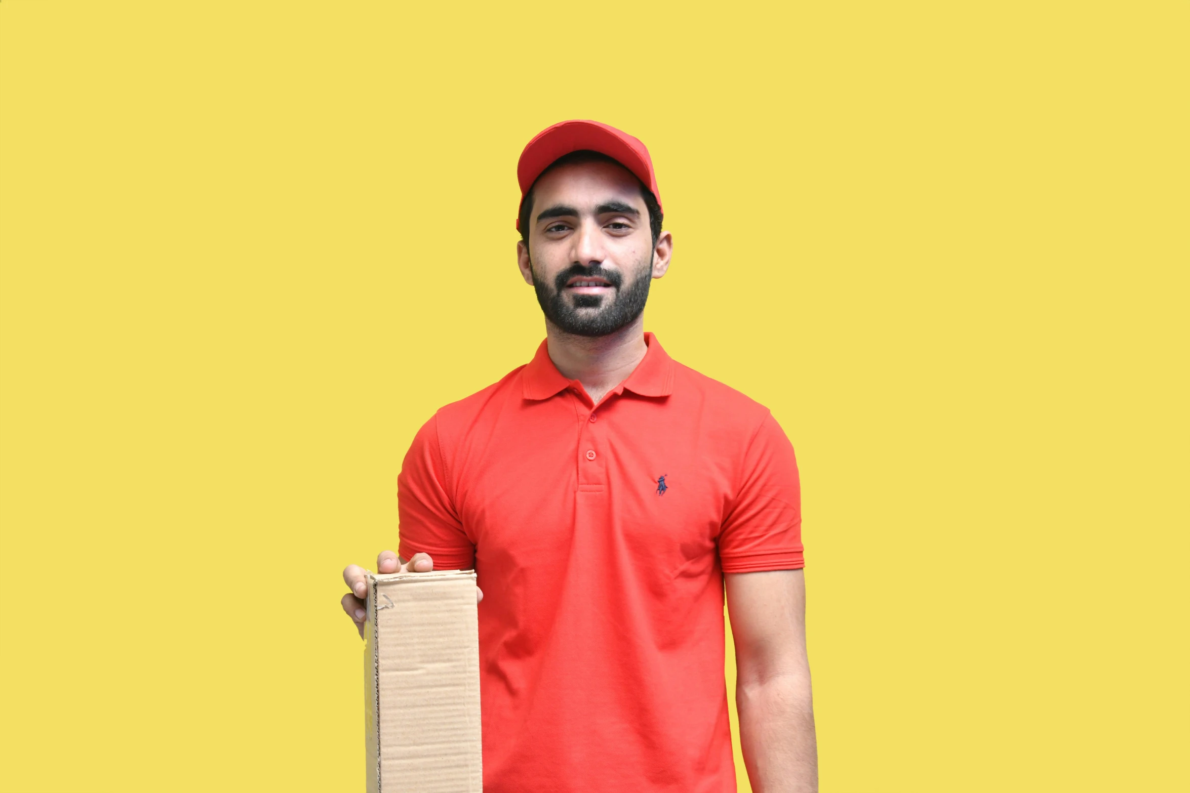 man with beard wearing red polo shirt holding piece of cardboard