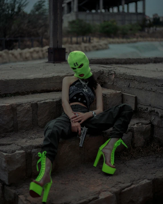a woman sitting on the steps with bright neon green shoes