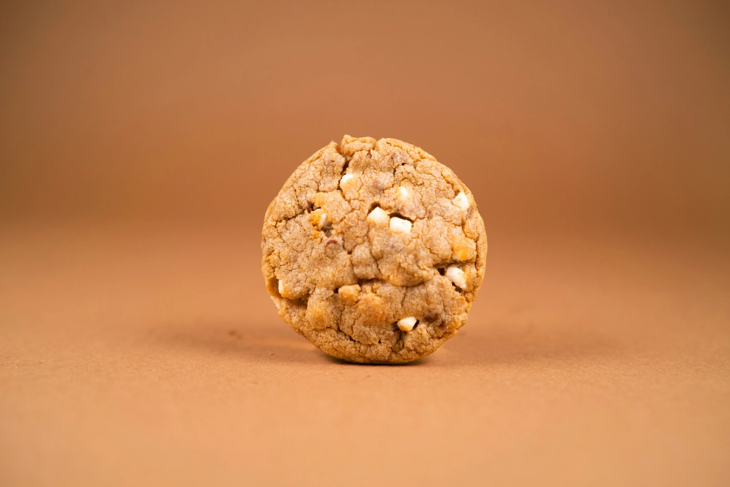 a close - up view of a round cookie with some nuts on top