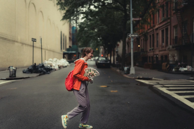 a man that is standing on the street with a backpack