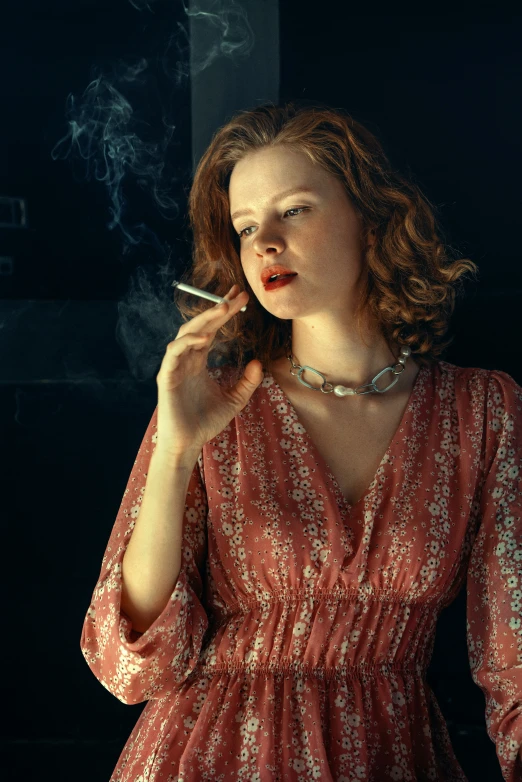 a woman is smoking cigarette in a dress