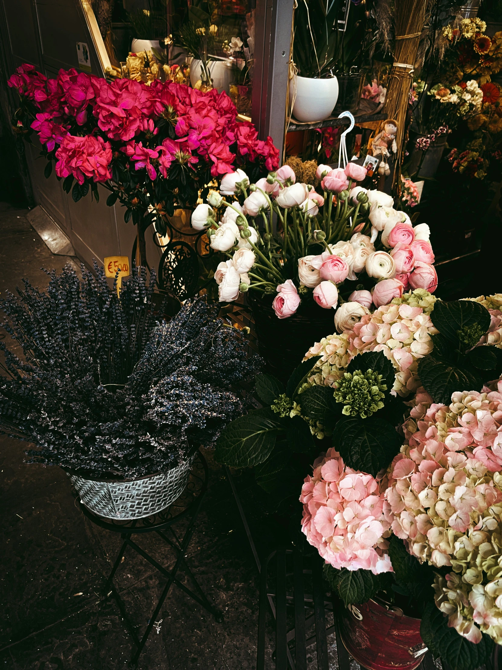 many different flowers in pot outside on a table