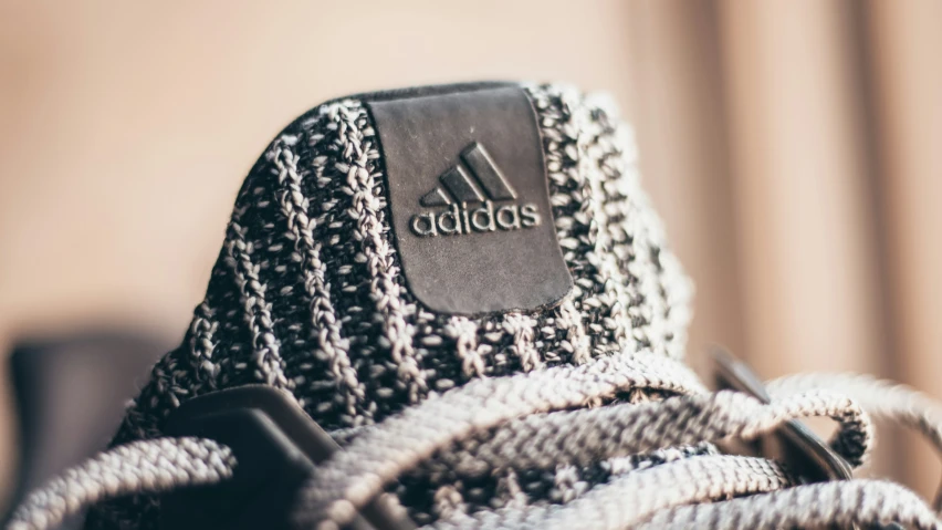 a closeup view of a black adidas hat