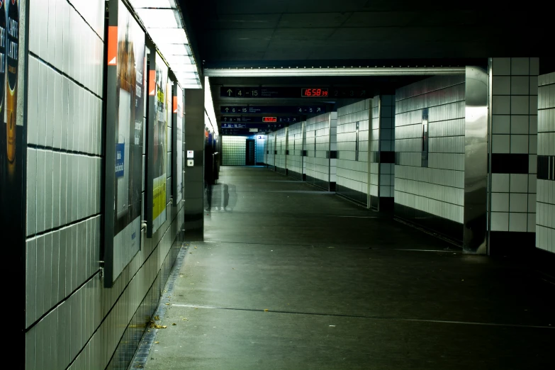 a long hallway is dimly lit with lights