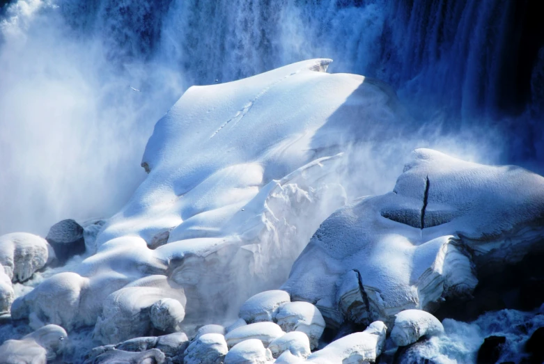 an image of a waterfall surrounded by snow