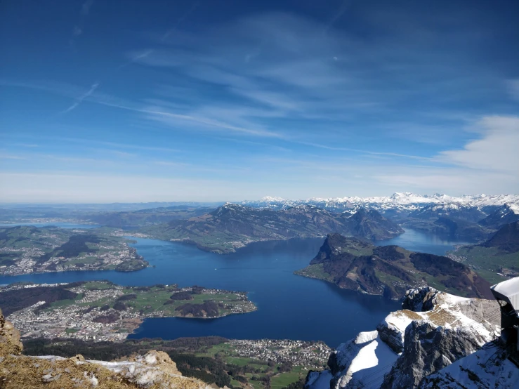 a snowy landscape with mountains and lake below