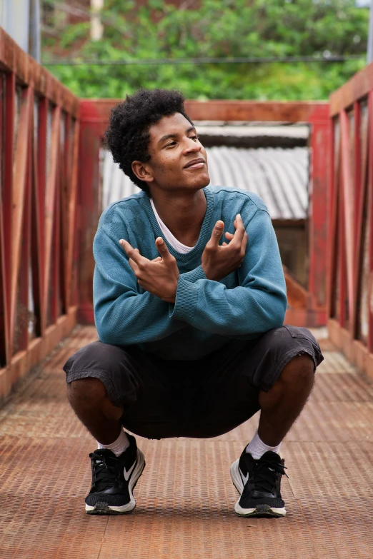 a man kneeling down with his hands together