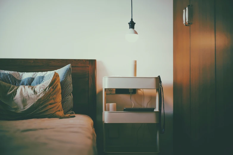 the bedroom has an interesting wood cabinet with a nightstand in it