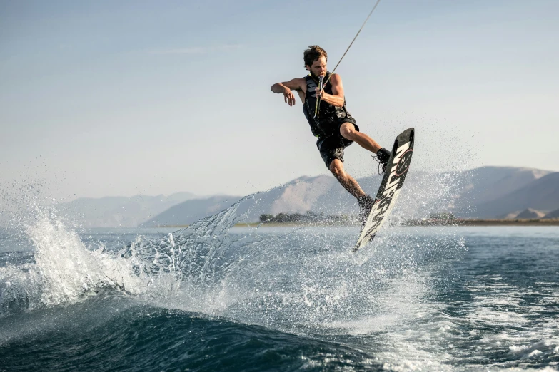 an athlete is doing tricks on the water