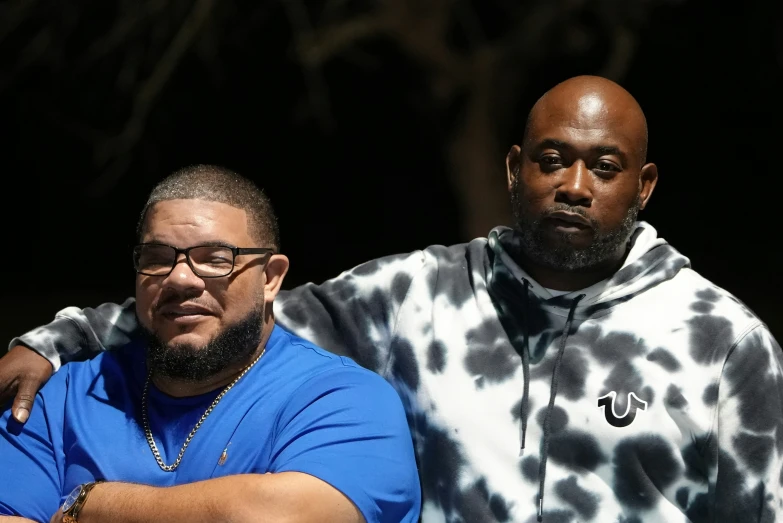 two black men in matching clothing stand together