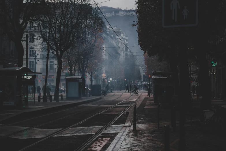 rain falls on a street as a train passes