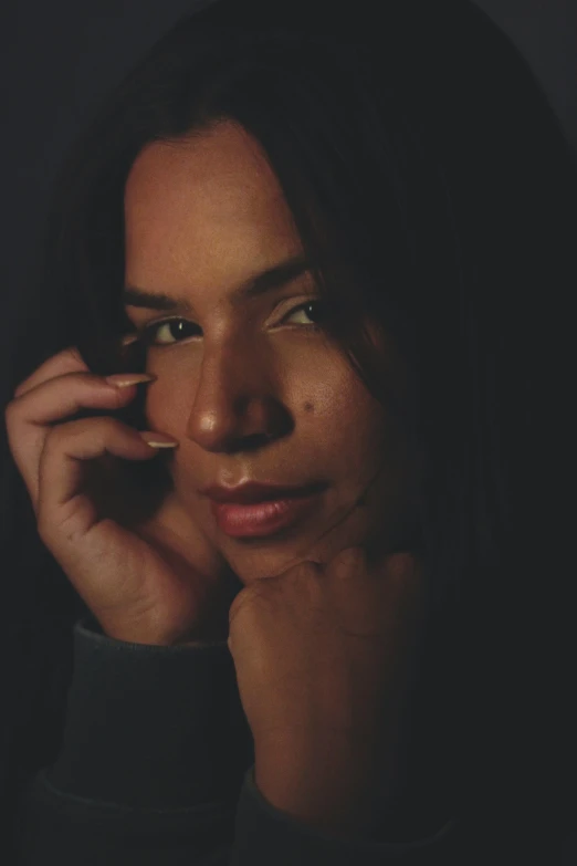 a woman with long hair talking on the phone