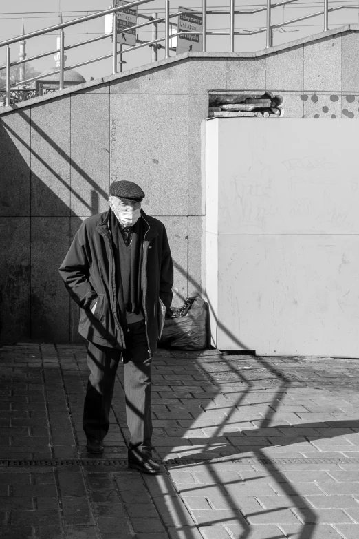 a man standing on a street next to stairs