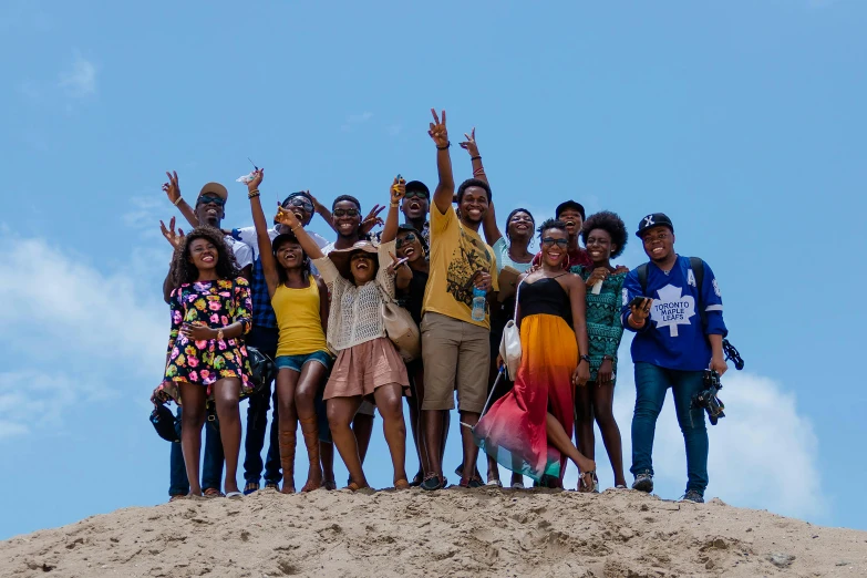 group of young people posing for po on dune