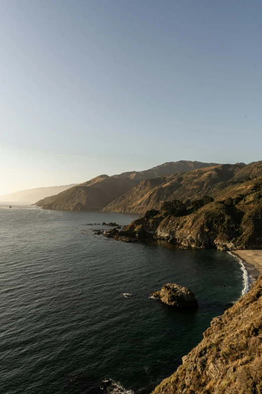 a boat on the water near a rocky shoreline