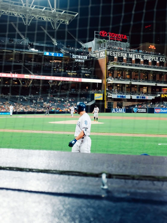 two baseball players in a stadium looking through the window