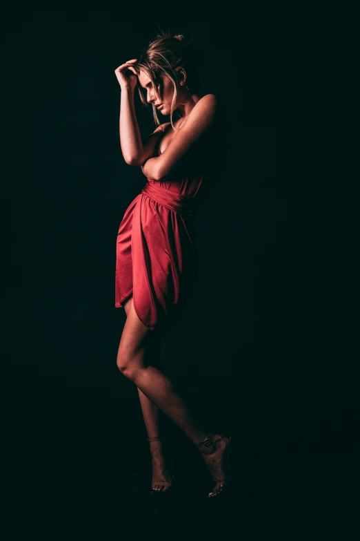 a woman is posing wearing a dress in a po studio