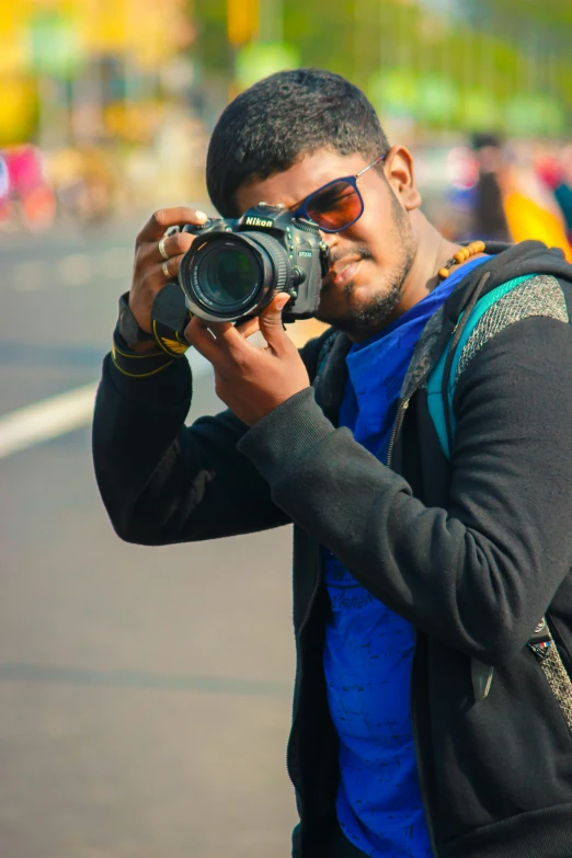 a man holding a camera taking pictures with it