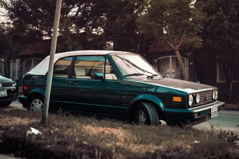 an old car parked on the side of a road