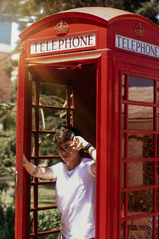 a person leaning out of a phone booth