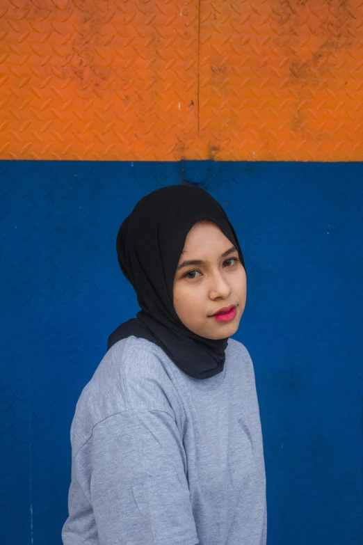 a woman with a hijab and a blue background