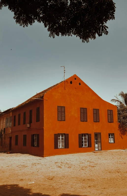 orange brick building near the desert with sp vegetation