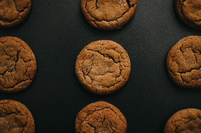 there are nine cookies with icing on top of the cookie sheet