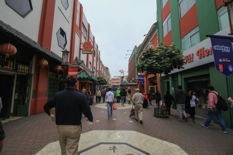 people walking on the road in a shopping center