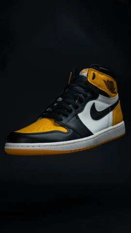 the air jordan 1 is in flight with black and yellow accents