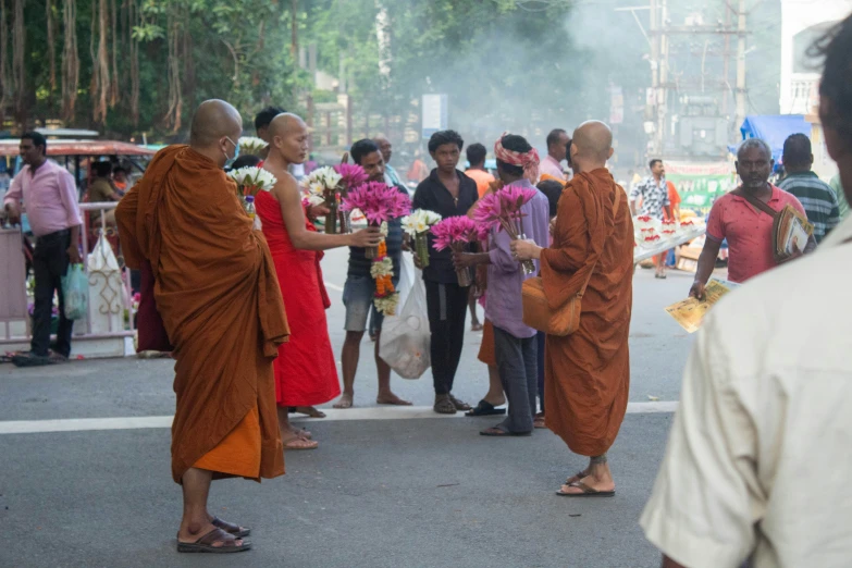 several people on the street walking and releasing flowers