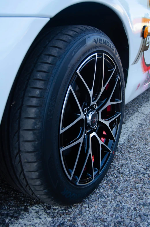 the wheels on the white car are black and chrome