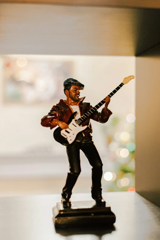 a miniature guitar player statue with an electric bass