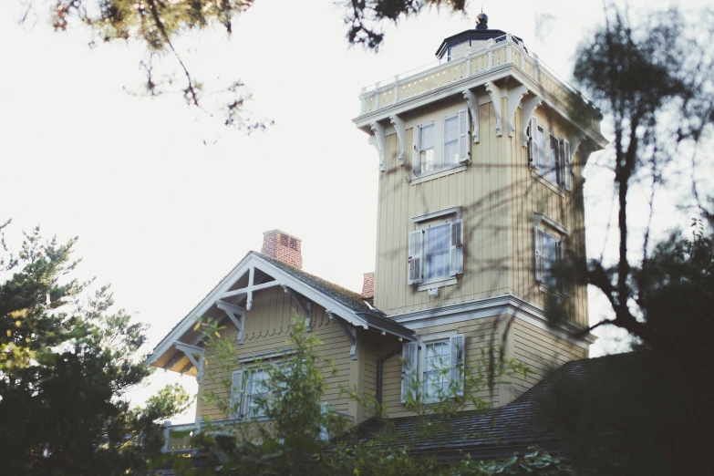 an old yellow house with a clock on it