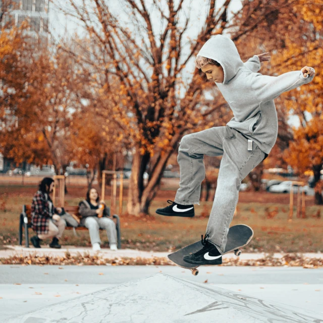 a man with a skateboard in the air over the ground