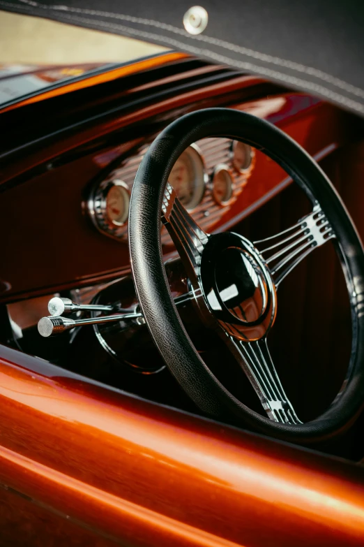 a close - up of the steering wheel and dashboard of a brown car