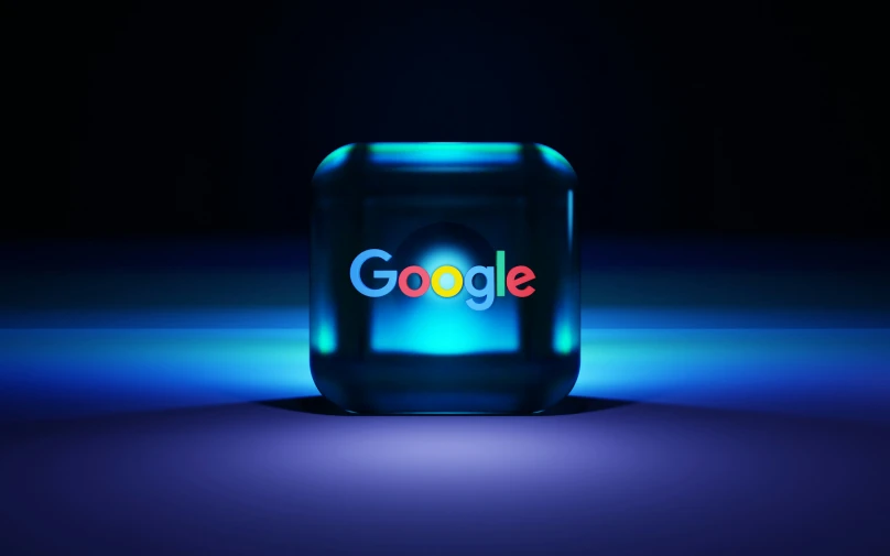 the lit up logo of the google logo on a dark background