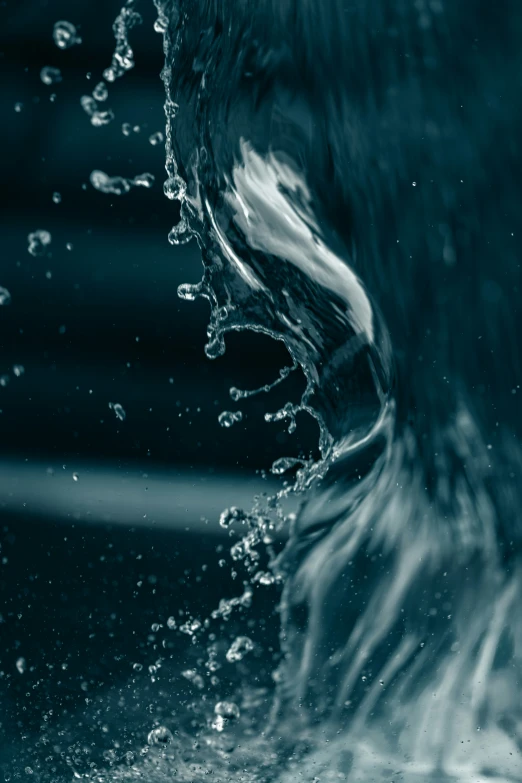 a white surfboard in the middle of water being splashed