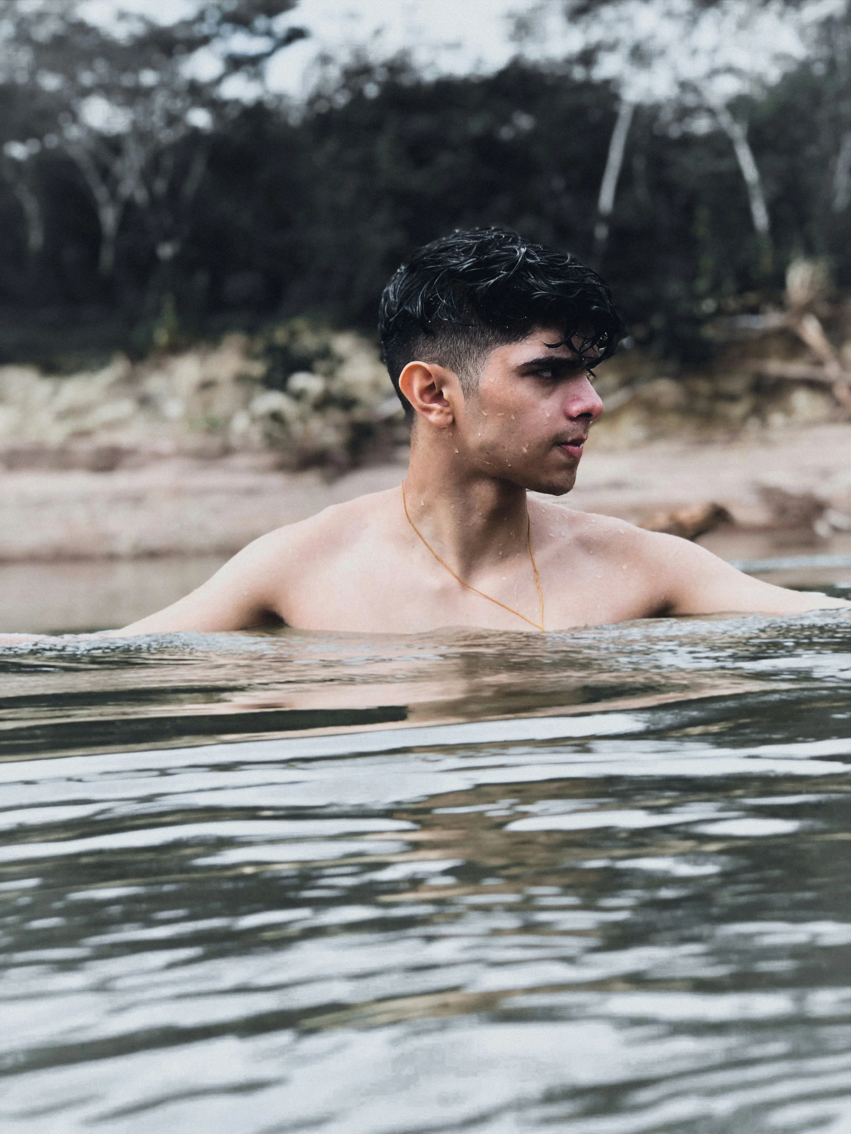 a man is submerged in water looking off into the distance