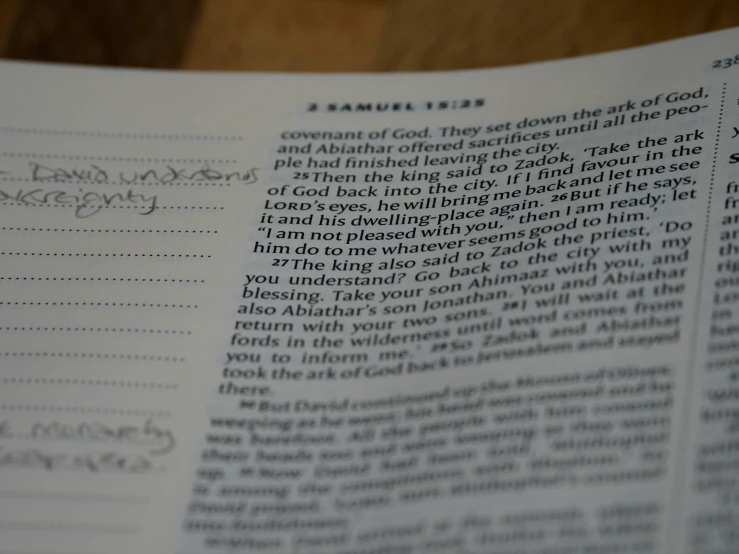 an open bible book with handwritten verse