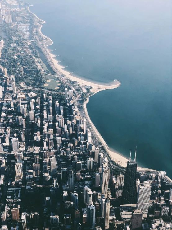 the city skyline from above, near a large body of water