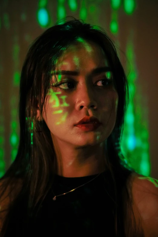 woman with her eyes illuminated by green lasers