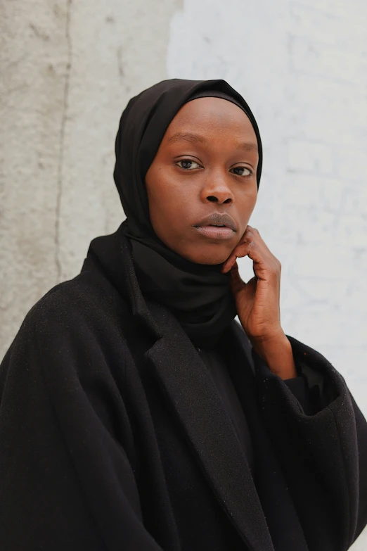 a woman with a headscarf looking at the camera