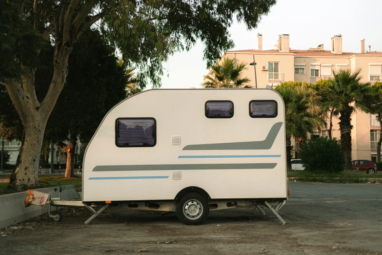 there is a small camper in the parking lot