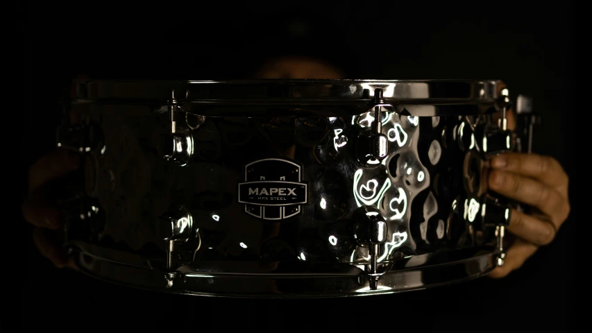 a shiny black s s - drum, taken from below