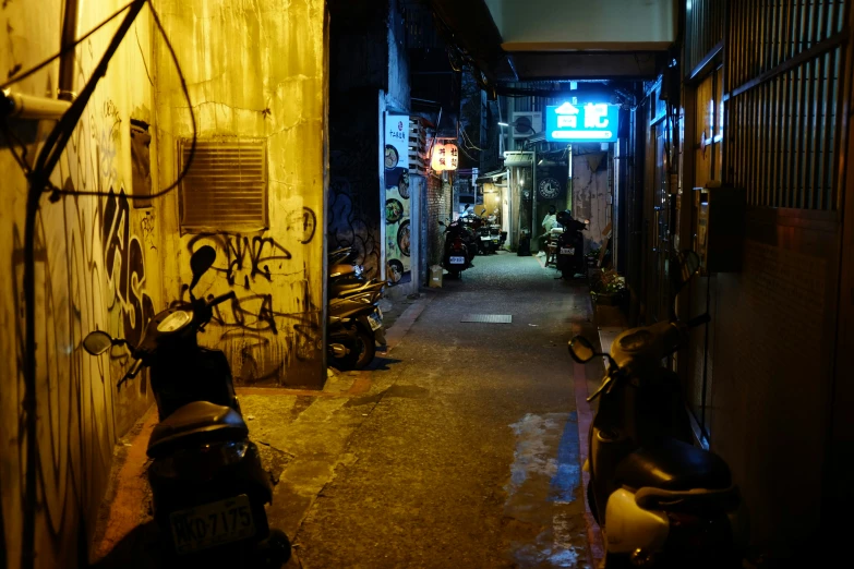 a long alley with scooters parked in the middle