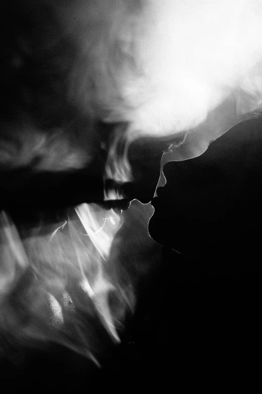 a woman has her back to the camera, while a smoke cloud hovers over her